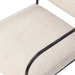 Close-up from above showing tightly woven cream upholstery on seat cushion