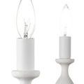 Close-up of candle-shaped bulbs on white textured holders with turned wood appearance