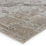Close-up side angle showing texture and edge binding of vintage medallion gray and ivory rug