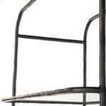 close-up of hammered texture on vertical metal bar and glass shelf edge from side angle