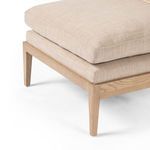 Close-up of Kenzo Chair front leg and cushioned seat corner illustrating fabric texture and wood finish