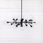 Chandelier shown from slightly lower angle with clear view of glass bulbs and iron arms