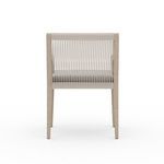 Rear view with clear visibility of taut vertical ropes and pale wood frame