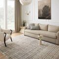 Soho Pebble Charcoal rug styled in a bright living room with beige sofa and armchair