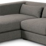 Detailed view of sectional corner with lumbar pillow and soft fabric texture