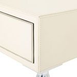 Close-up showing stitched ivory leather covering the table drawer and top