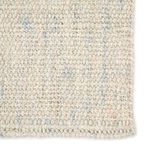 Detailed close-up of braided weave pattern highlighting ivory and pale blue fibers