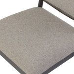 Close-up detail of chair seat cushion fabric texture and edges over wooden frame