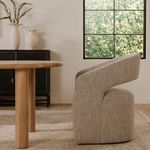 Barrow chair side view near window showing open backrest and textured boucle fabric