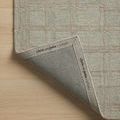 Corner of Polly Fog / Wheat Rug lifted to reveal branded fabric edge and craftsmanship details