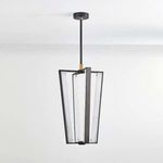 Matte black and brass Edgemere Pendant hanging from ceiling in a bright room with white walls, unlit alabaster panels