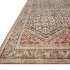 Low angled side perspective of Loren Rug highlighting thin profile and softly muted border pattern