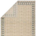 Back corner of rug pulled back to reveal soft texture and light contrast between front and reverse patterns
