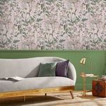 Edulis Blush wallpaper installed as a floral feature wall above green wainscoting in a stylish living room setting