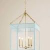 Soft Arctic Blue Rosalie Lantern with scalloped and slatted details, four brass light sockets, and hanging chain