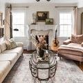 Skye rug styled in a cozy living room with beige couch, glass coffee table, and guitar near fireplace