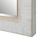 Close-up showing the ridged texture and layered whitewash paint detail on the rattan frame corner