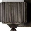 Close-up detail of bronze base with vertical ridges and round finial on Bryce Bath Wall Sconce