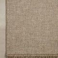 Top corner view highlighting rug’s fringe and edge stitching on a neutral floor