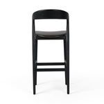 Rear view of bar stool showing backrest shape and leg structure with foot rails