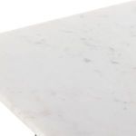 Marble tabletop edge detail showing polished white surface and thin profile