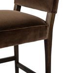 Close-up showing the plush padded seat with smooth velvet upholstery over wood frame