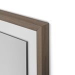 Close-up of rustic walnut frame corner showing wood grain and layered photo paper edges