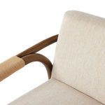 Close-up of beige fabric seat cushion and oak armrest wrapped with tan cotton rope