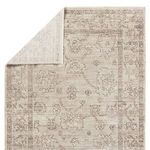 Camille rug corner folded to reveal lighter cream underside and woven backing