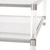 Close-up of the coffee table corner showing clear acrylic leg with stainless steel accents and glass shelf edge