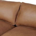 Close-up on plush back cushions with welted edges meeting at center