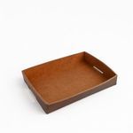 Angled side view highlighting the smooth leather texture and cut-out handles on tray sides