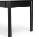 Partial view of desk corner with smooth rounded edges and black finish