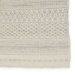 Close-up of a corner section highlighting the detailed geometric tribal weaving in cream and light gray tones