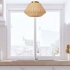 Ceiling light installed above kitchen sink with window and white cabinetry background