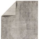 Dune rug flipped corner revealing solid taupe backing fabric