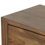 Side profile of dresser emphasizing tapered legs and framed panel sides
