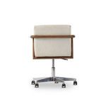 Back view of Rosie desk chair showing light wash oak frame and upholstery with chrome swivel base