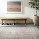 Margot rug displayed in a minimalist room with light gray floor, wooden bench, and framed art above