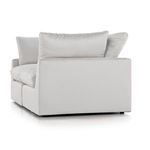 Right side view showing solid light beige fabric upholstery and removable back cushions