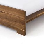 Detailed view of footboard lower corner and baseboard cutout revealing craftsmanship
