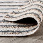 Bent rug corner revealing underside weave and thickness of natural fiber construction