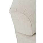 Detailed close-up of rounded armrest seam stitching on beige fabric