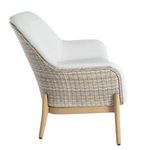 Side profile emphasizing woven wicker wrapping around curved frame beneath white vinyl seating
