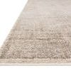 Close-up angled view showing low-profile pile and fine woven border detail on beige rug