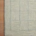 Close-up showing texture and weave of Francis Silver / Sky Rug pattern with hardwood floor beneath