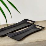Alternate angled view on stone surface emphasizing long rectangular shape and handles