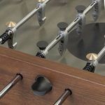 Close-up of foosball rods with black score counters and metallic player figures