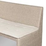 Close-up detail of rattan backrest showing the woven pattern above seat cushion