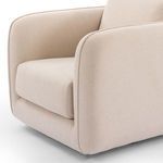 Angle view showing seat depth and plush cushioning in cream upholstery